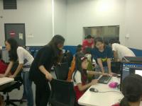 Friendly volunteers assisting young children in using Game Editor